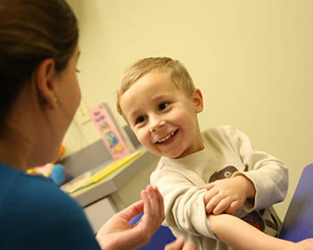 ABA student works with a child in the CARE clinic